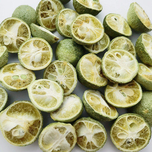 Variety of loose dried fruits, pear slices, apple pieces, kumquat and lemon slices, dried fruit tea