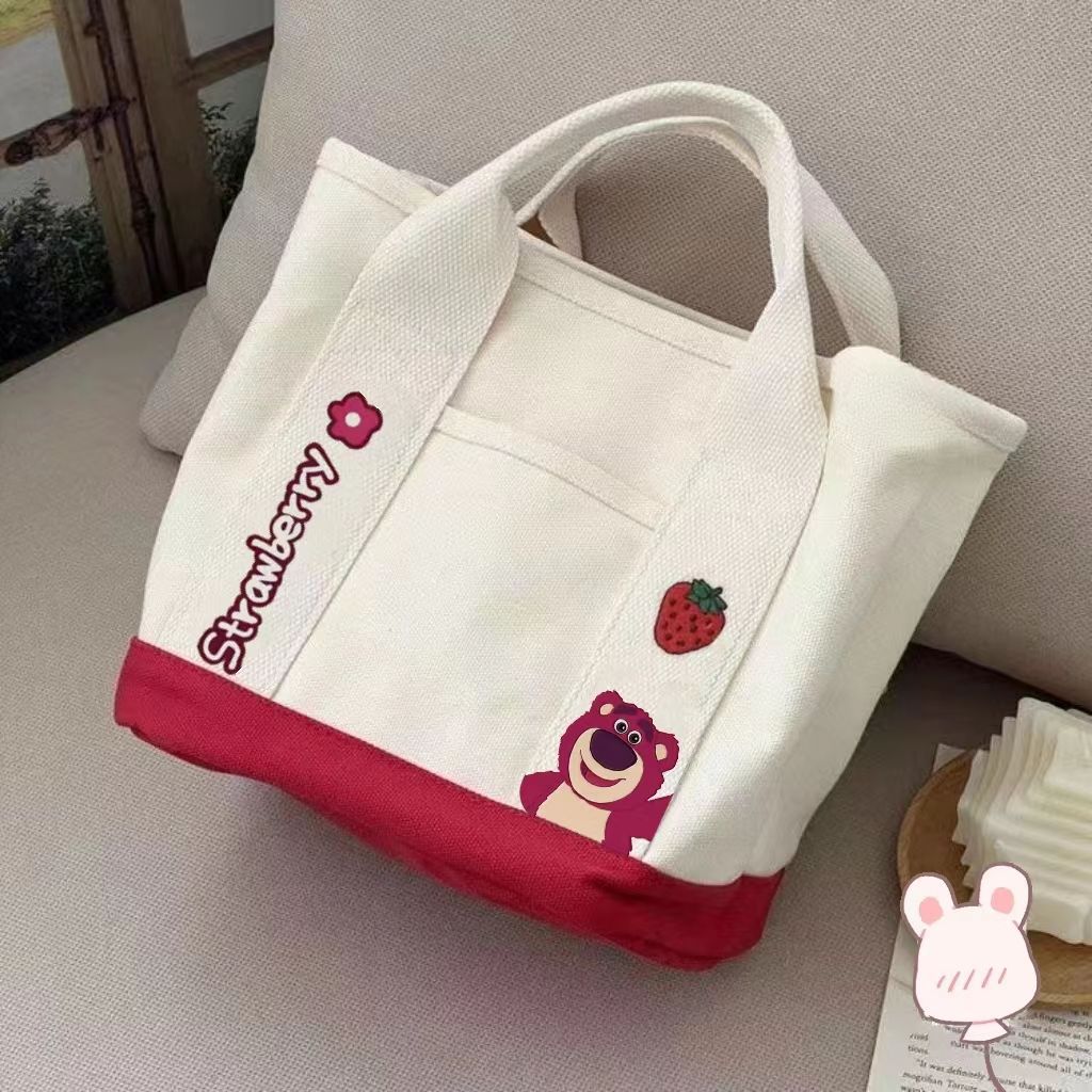 A small handbag is carried by a female student going out. She is carrying a 2024 new style bag, a mini canvas bag, and a Korean version bento bag for female students undefined