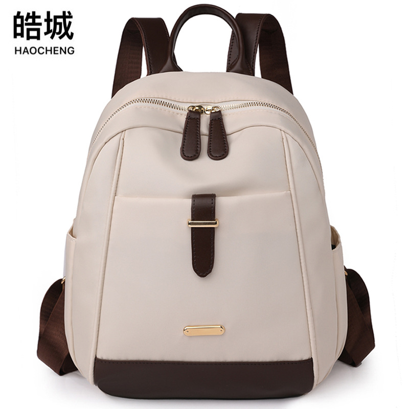 Spot al por mayor 2023 nueva mochila de nailon para mujer coreana moda contraste color al aire libre mochila de viaje portátil marea