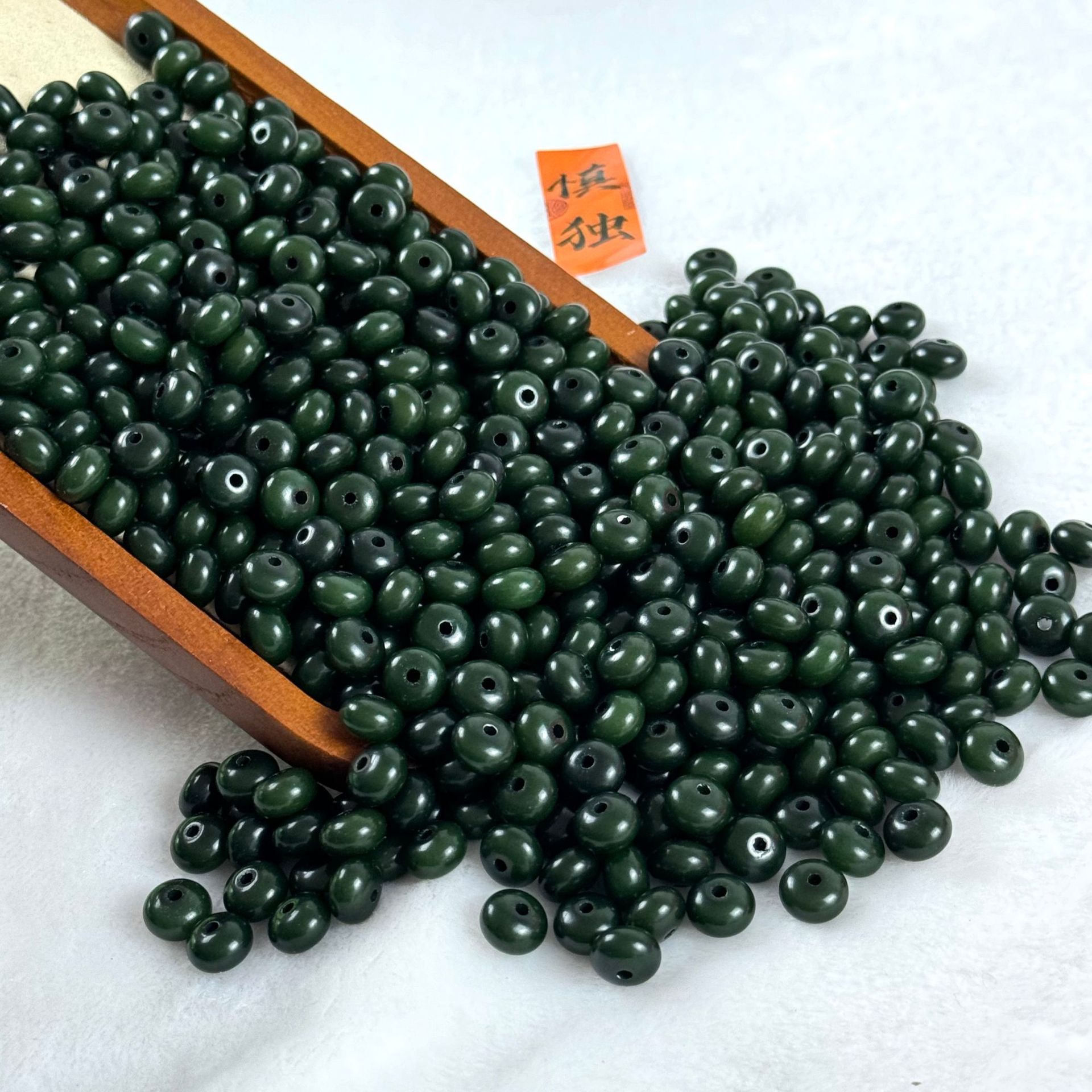 Бусины темно-зеленые счеты 6*9мм.