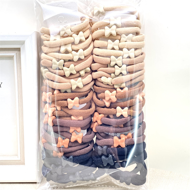 Nueva cinta para el pelo estilo coreano con lazo y cuentas en color té con leche, bandas para el pelo de colores primaverales para tiendas físicas, supermercados y venta al por mayor en tiendas de 2 yuanes.