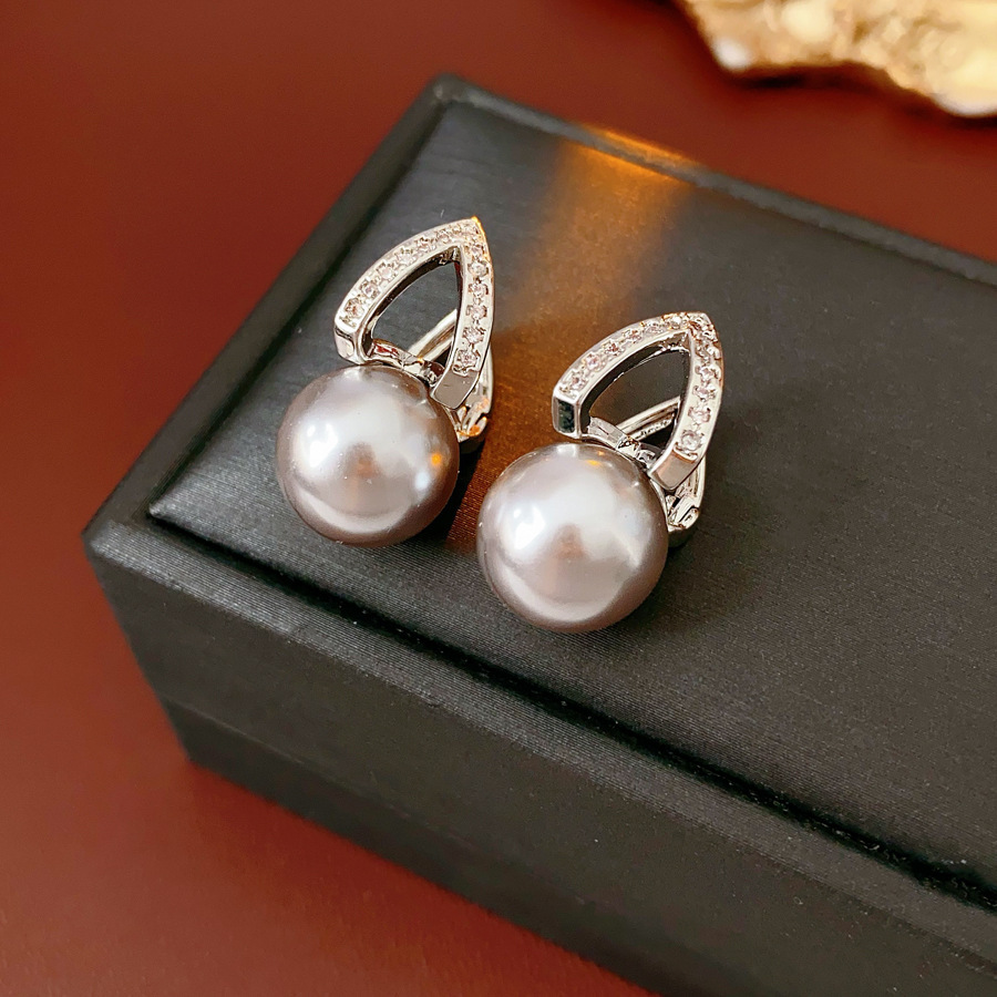 Pendientes de perlas de circón de alta gama de moda Pendientes de lujo ligero retro de nicho francés Pendientes nuevos al por mayor 2025