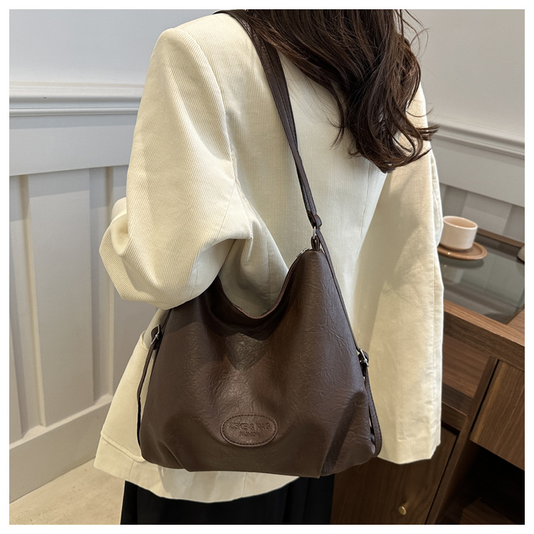 The 2024 new pleated tote bag is a large-capacity casual and fashionable backpack for women, featuring multi-functional texture and a single-shoulder crossbody bag undefined