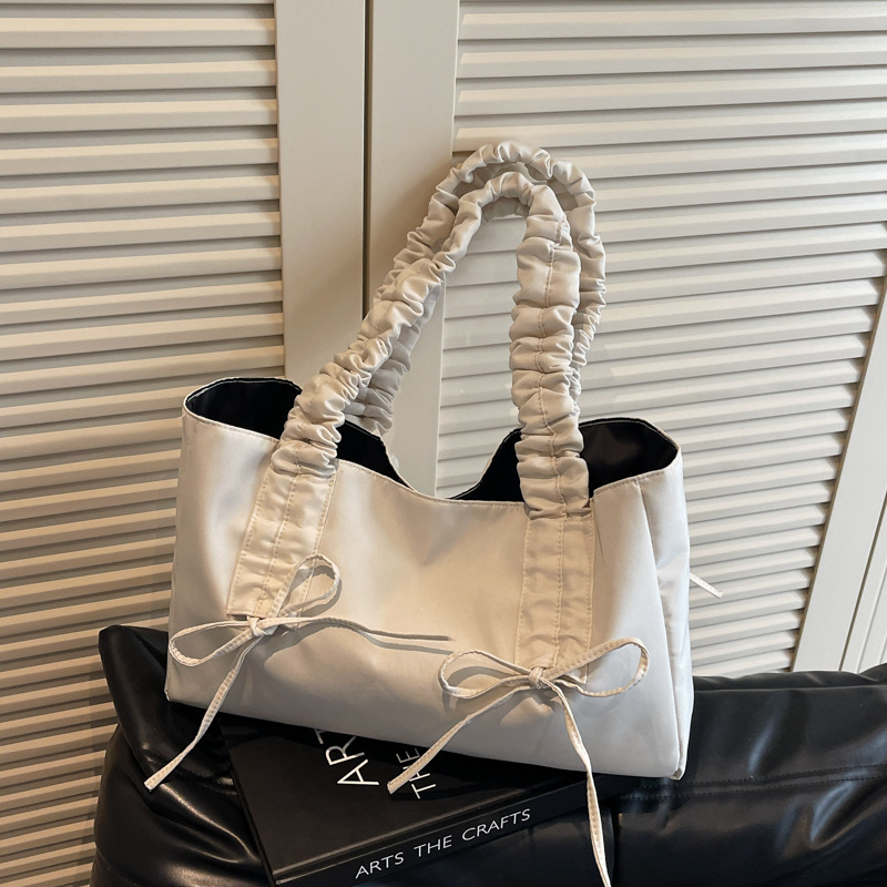 Bolso de arco de la mujer 2025 nueva moda coreana bolso de tela de gran capacidad bolso de mujer de alto valor facial