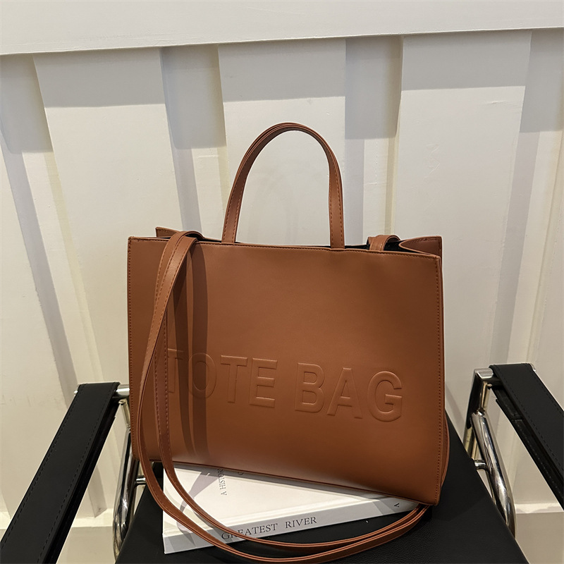 2024 nueva gran capacidad simple mochila de hombro texturizada bolso de mano letras de impresión clase viaje bolsa de mano