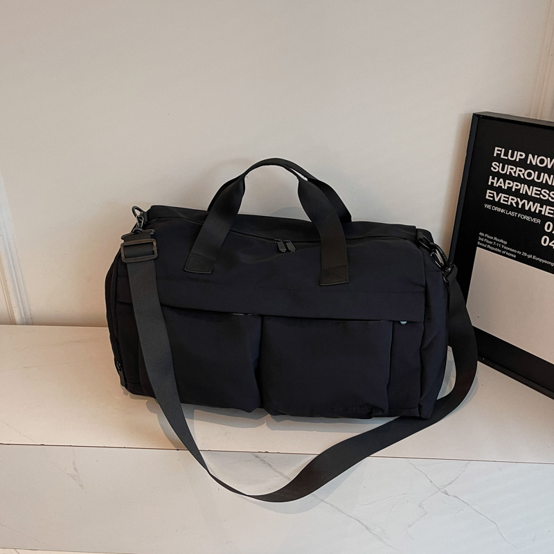 Nueva bolsa de viaje portátil simple y versátil, bolsa de equipaje de gran capacidad para mujeres, bolsa deportiva leve y casual de alta calidad.