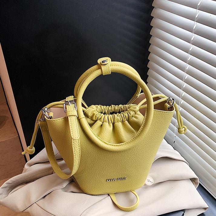 Bolsos de mano de nicho de tendencia transfronteriza para damas 2025 nuevo bolso de hombro simple de moda con textura bolso de cubo de todo fósforo