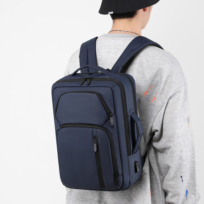 Nueva película de cuero mochila a prueba de derrames USB recargable de gran capacidad mochila de viaje de moda simple bolso de computadora para hombres