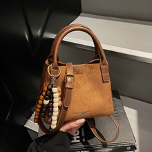 韩版简约休闲手提水桶包女2025秋冬新款百搭磨砂洋气单肩斜挎包女