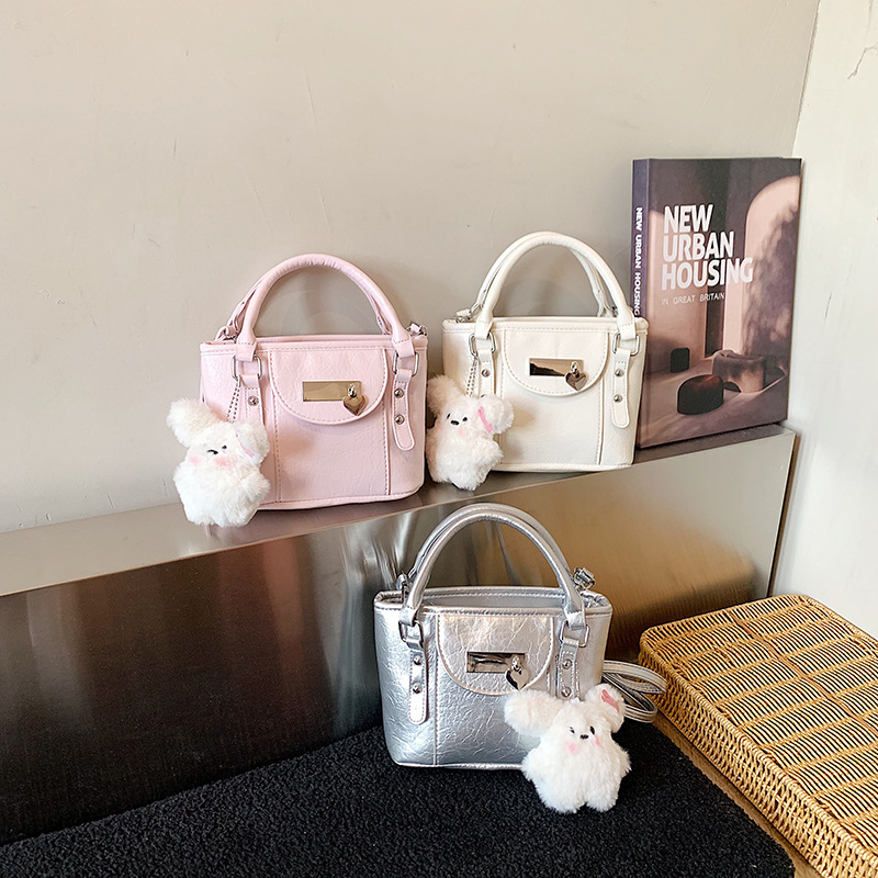 Nuevo bolso infantil transfronterizo simple bolso de bebé compacto color sólido lindo muñeca colgante bolso de cubo para hombres y mujeres