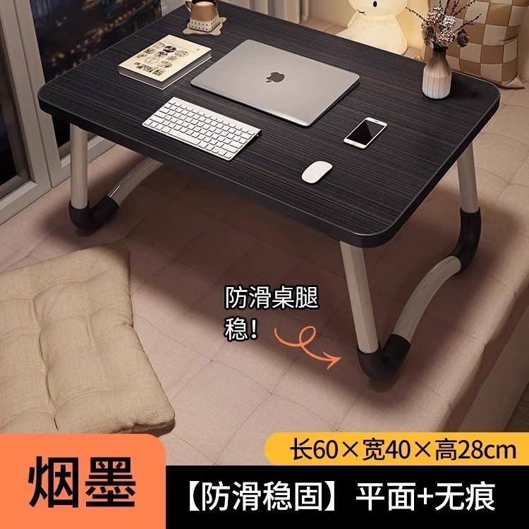 折り畳み可能なベッドの上の小さなテーブルは机のノートパソコンのテーブルを勉強します。|undefined