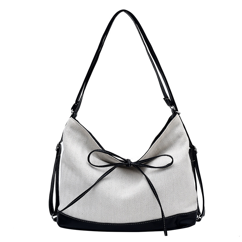 Bolsa de lona de nicho coreana para mujeres 2024 nueva moda de transporte de doble uso mochila de hombro universal