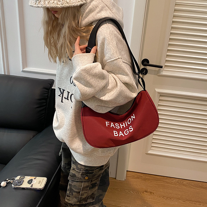 La versión coreana de la bolsa de hombro con estilo deportivo simple es una bolsa de ropa de trabajo y tela Roja de Internet.