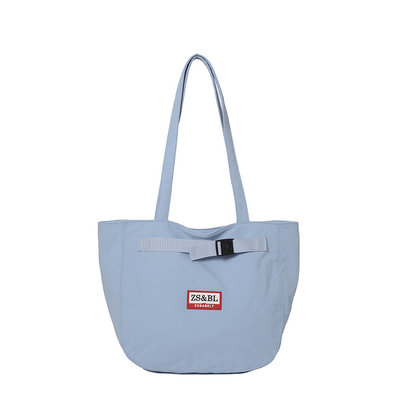 Bolso de letras coreanas 2025 verano nuevo bolso femenino bolso de lona para estudiantes bolso de hombro casual de gran capacidad