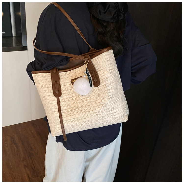 This is a new 2025 summer beach-style women's bag with a simple and versatile hand-held design. It's a single-shoulder vacation woven bag undefined