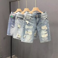 日本のファッションブランドの水洗いデニムの半ズボンの男性の街頭の復古の穴を破って古い5分のズボンをします。