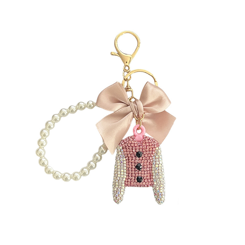 Versión coreana del lazo Llavero de ropa de diamantes completos Llavero de coche de diamantes flash creativo Colgante de bolsa de cadena de perlas de alto brillo