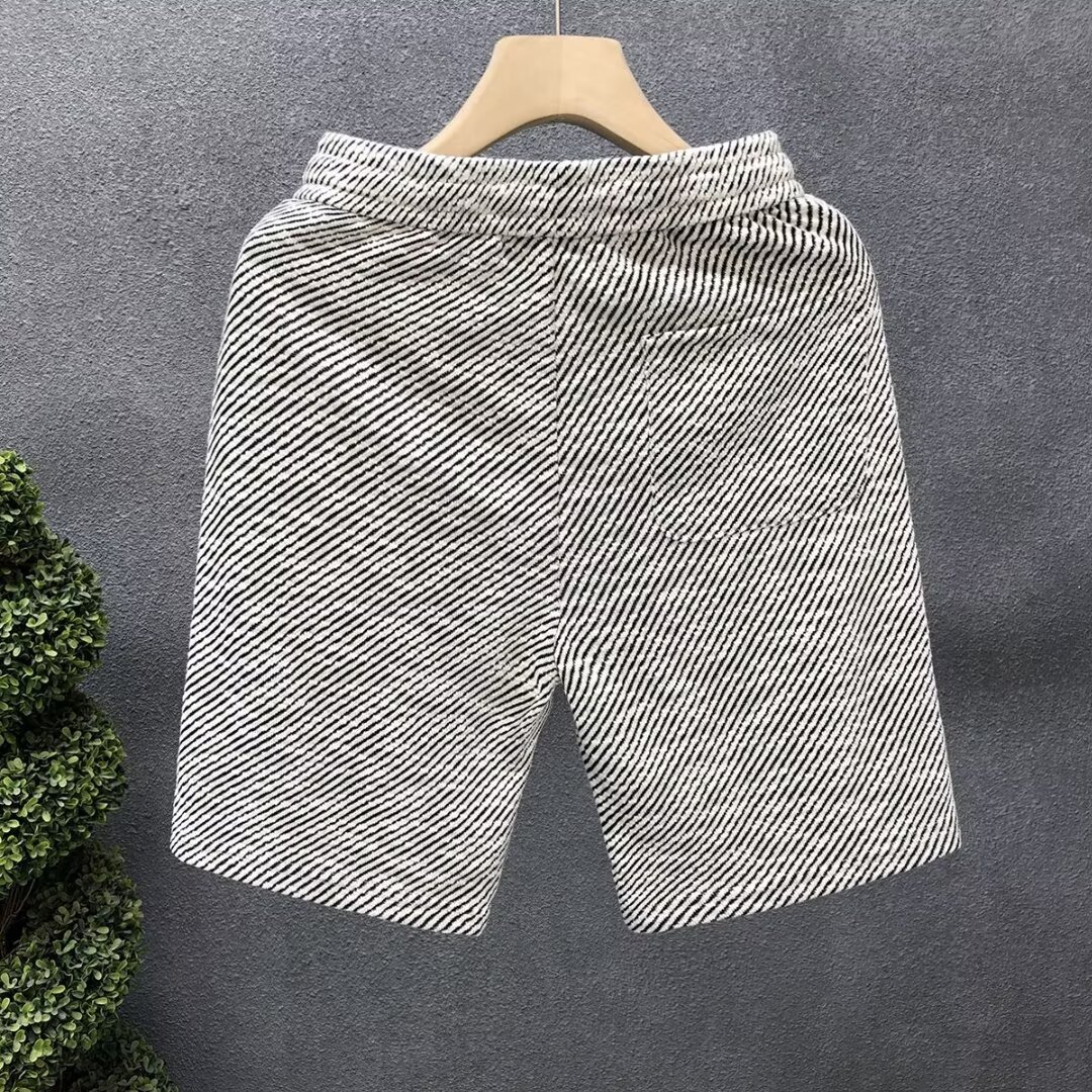 Verano delgado estilo americano retro sensación de diseño simple pantalones cortos a rayas nicho de hombre grande pantalones casuales sueltos