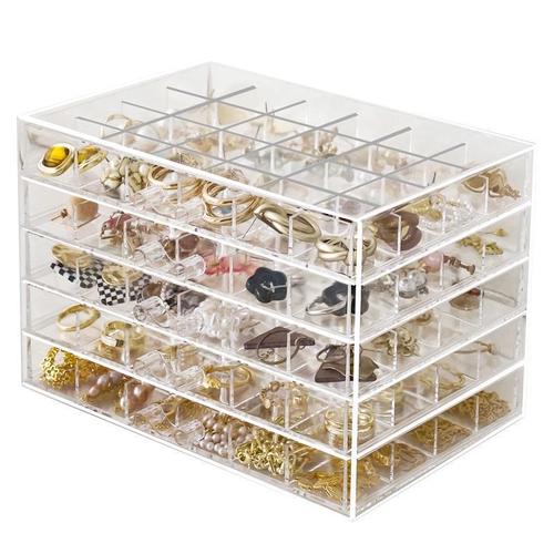 A transparent jewelry box with compartments for earrings, necklaces, rings, and beads