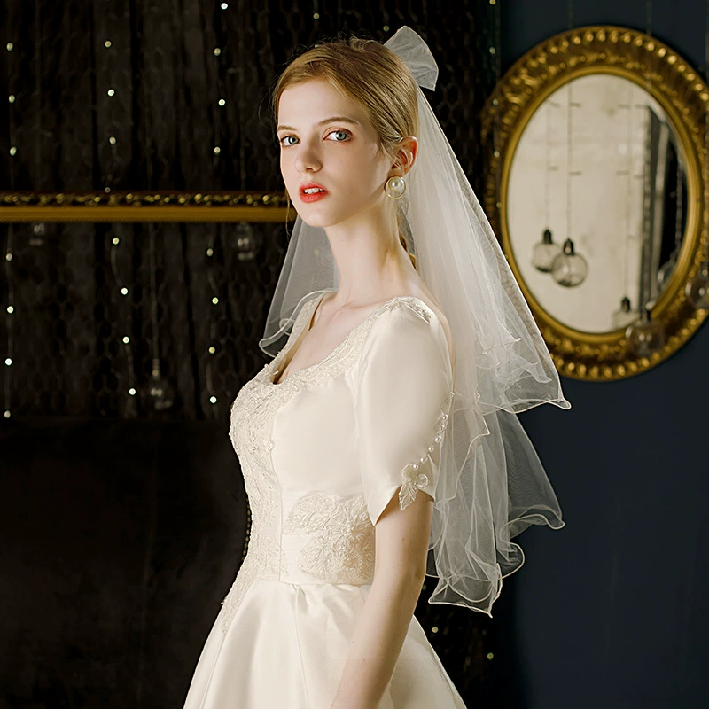 Cute short white bride's veil with bow
