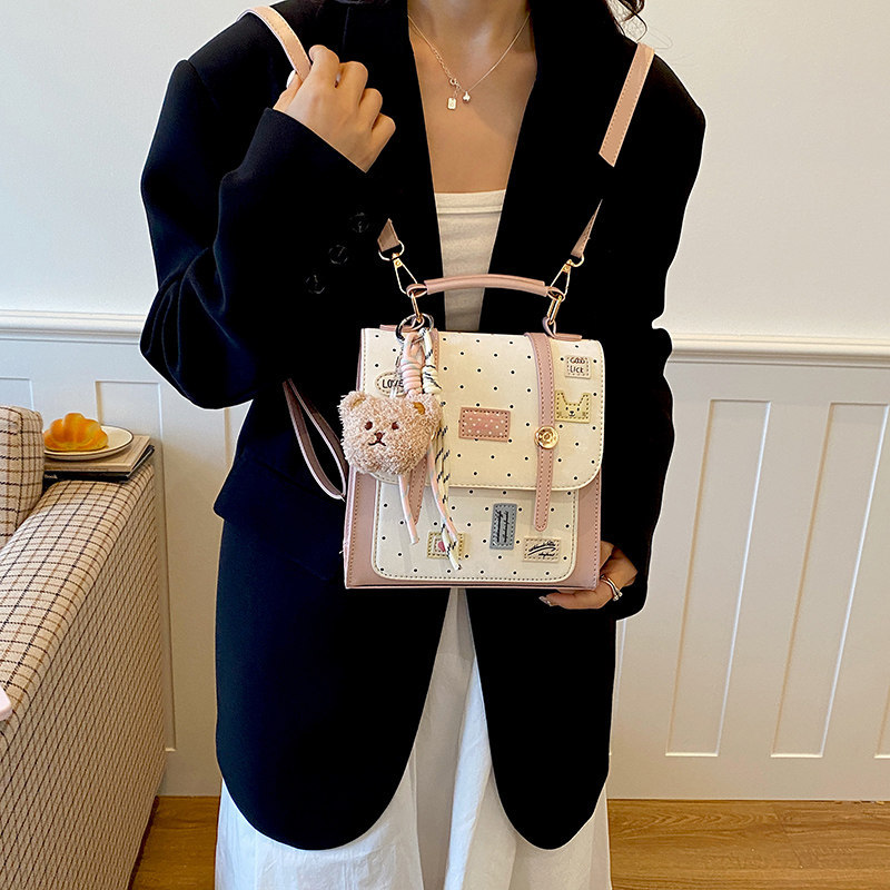 Mochila dulce chica de viaje universal clase de moda de punto de onda mochila de viento diaria 2026 nueva universidad femenina