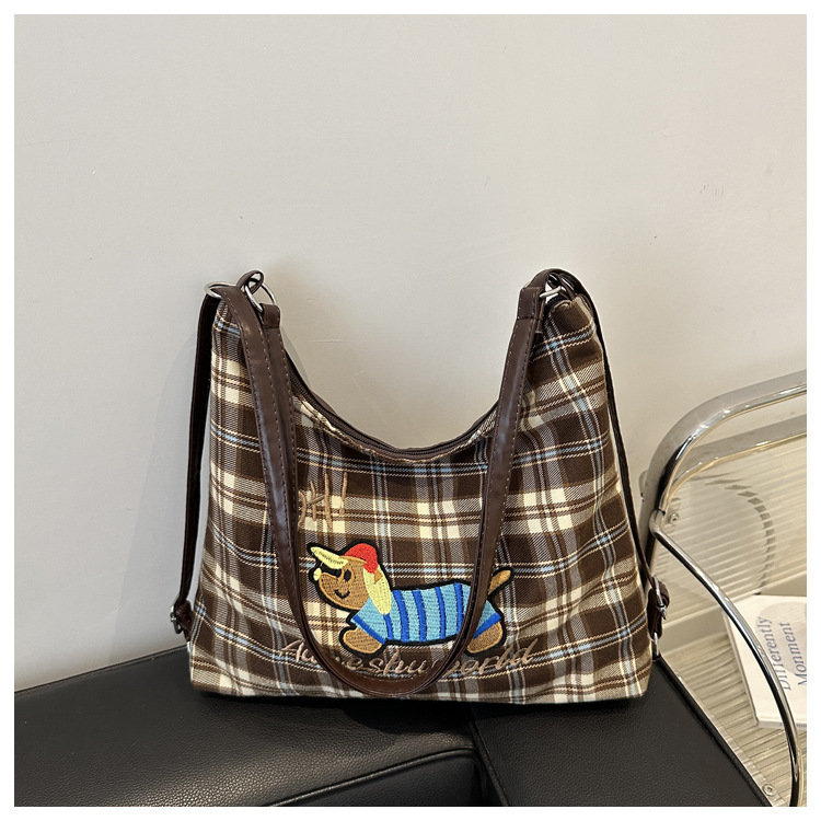 A new 2024 trendy and stylish backpack for women, featuring a cartoon checkered single-shoulder crossbody bag and a tote bag undefined
