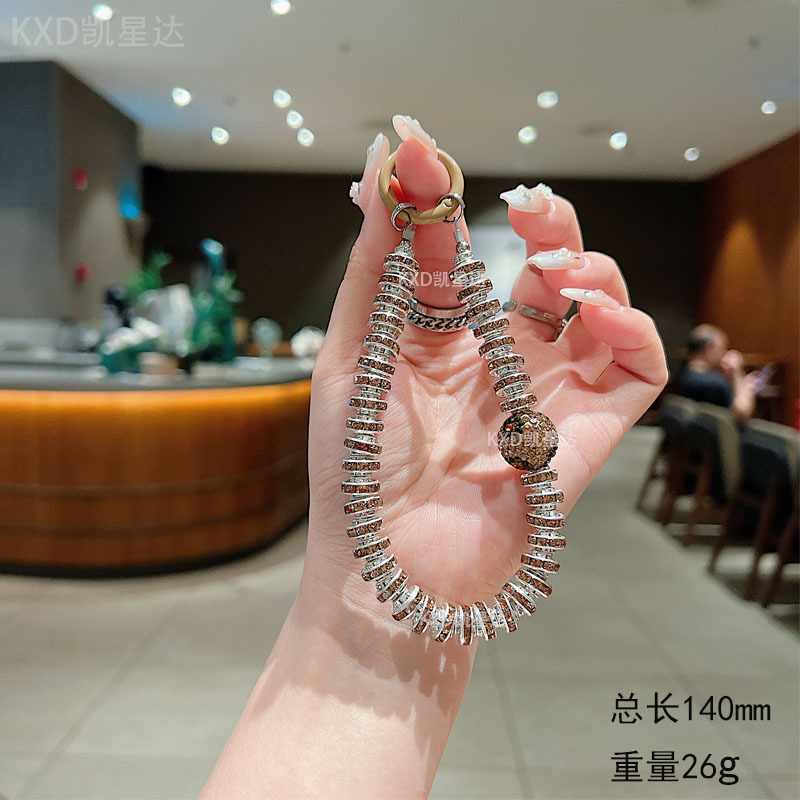 다이아몬드가 박힌 카키색 휴대폰 체인