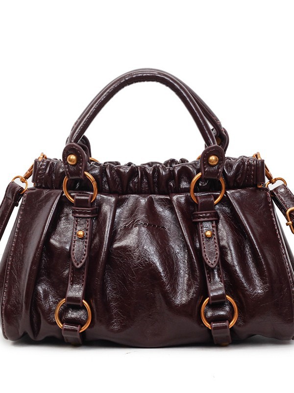 Retro bolso de mano plegable mujer 2025 otoño y invierno nuevo nicho de diseño bolso de cubo de viaje mochila de hombro