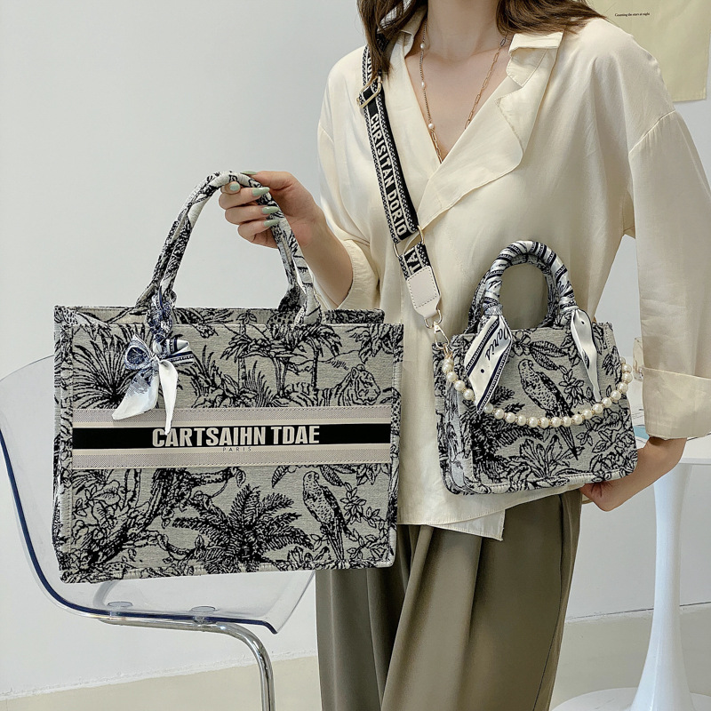 Bolso de mujer 2025, nuevo estilo transfronterizo, bolso tote con estampado de letras, con un toque de alta gama, diseño exclusivo, práctico para salidas y viajes diarios.