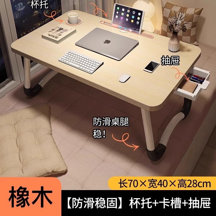 折り畳み可能なベッドの上の小さなテーブルは机のノートパソコンのテーブルを勉強します。|undefined