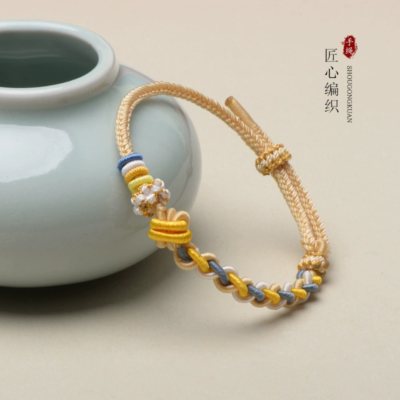 Woven accessory handmade with pigtail, golden red rope bracelet