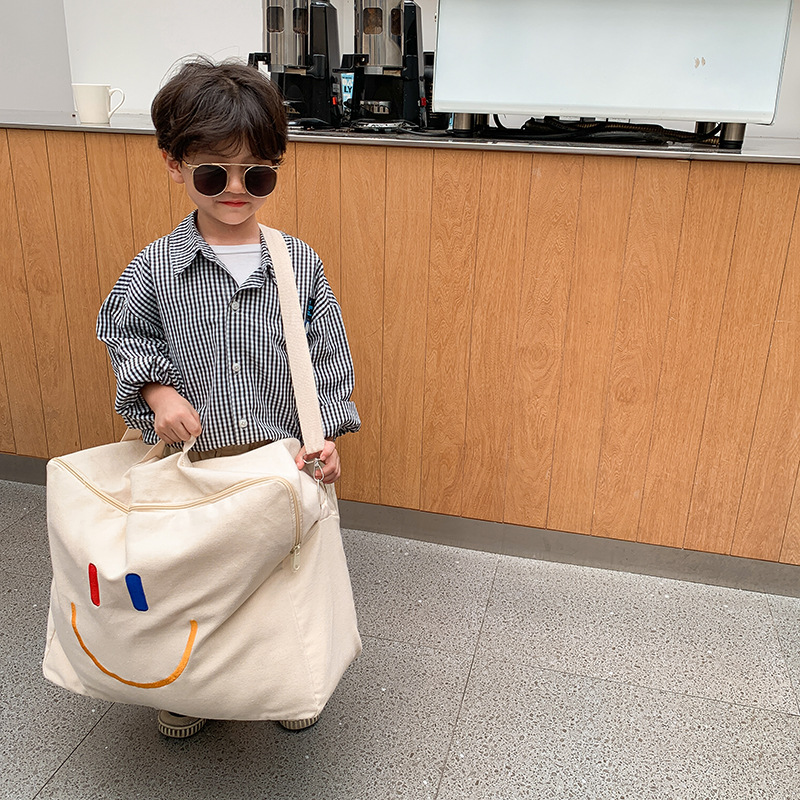 Bolsa Infantil Otoño/Invierno 2025, Nueva Bolsa con Cara Sonriente, Bolsa de Hombro de Lona de Gran Capacidad, Bolsa de Almacenamiento de Edredones Portátil para Jardín de Niños