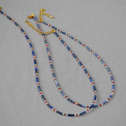 A handmade beaded necklace with new Chinese style, featuring a mix of vintage, literary, blue lapis lazuli, red agate, and genuine stones, with dot separators.