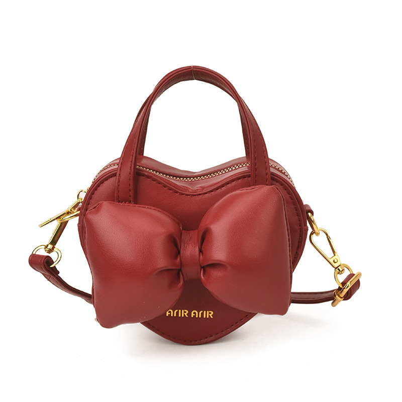 Mini lindos bolsos de mano en forma de corazón de melocotón, bolsos de hombro para bebés de color sólido, nuevos bolsos para niños transfronterizos