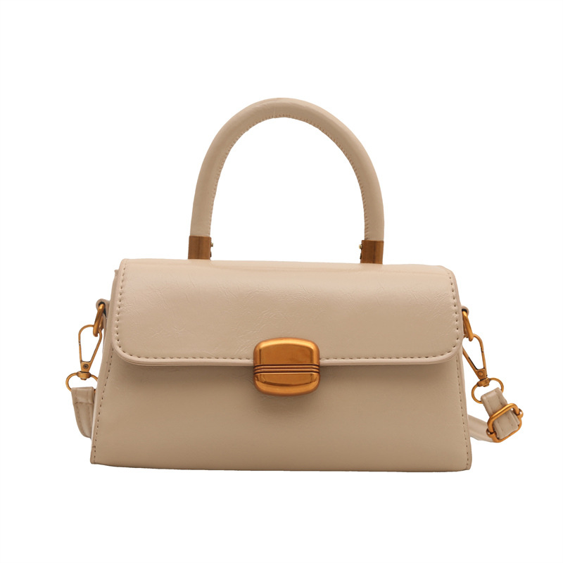 Nicho de diseño coreano bolso de mano 2025 primavera nuevo estilo simple de moda con cierre de flip de hombro monocolor bolso de mochila