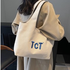 2025年の春の新型高級感の女子学生の特包の純色の刺繍の通勤の気性の金はわきの下の包みを合わせます。