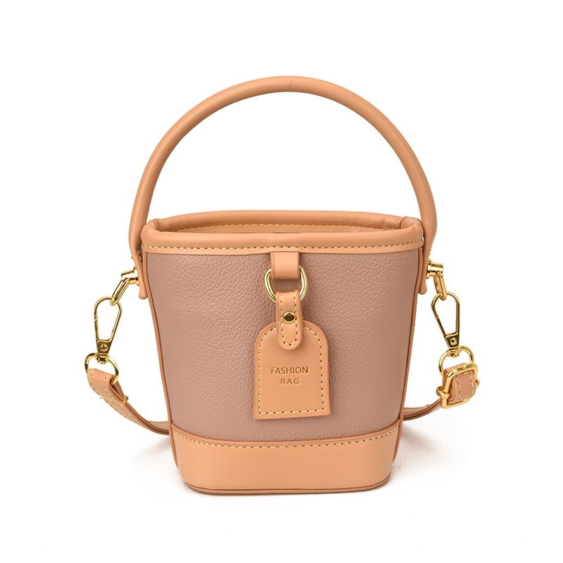 Mini pequeño bolso de cubo de mano para niños 2026 nuevo estilo de alta calidad de moda versátil bolso de mochila de estilo exterior