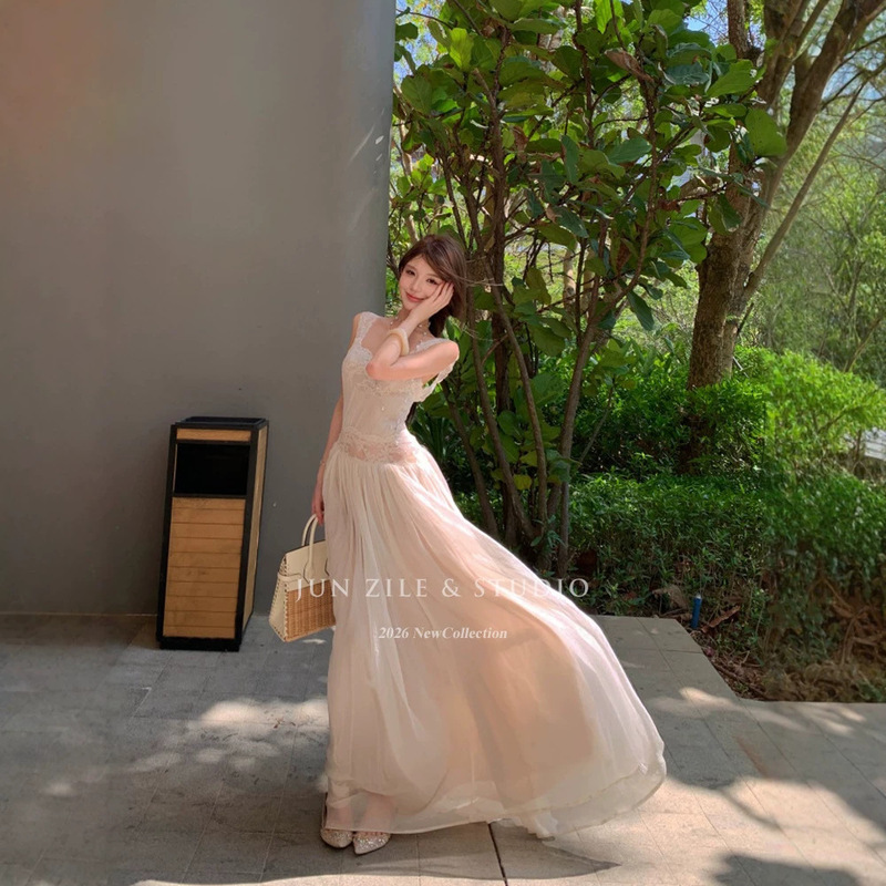 Atmospheric and alluring, this backless slip dress with lace detailing and a long, flowing skirt is an absolutely stunning dress that exudes a sense of luxury and sophistication