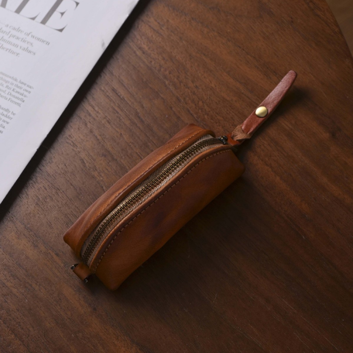 Vintage-style, distressed zipper key pouch, a portable mini key organizer for men, featuring a curved design and multiple compartments for coins and small items