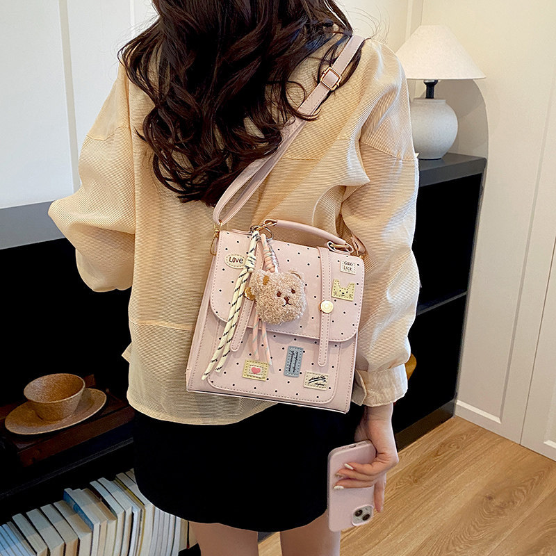 Mochila dulce chica de viaje universal clase de moda de punto de onda mochila de viento diaria 2026 nueva universidad femenina