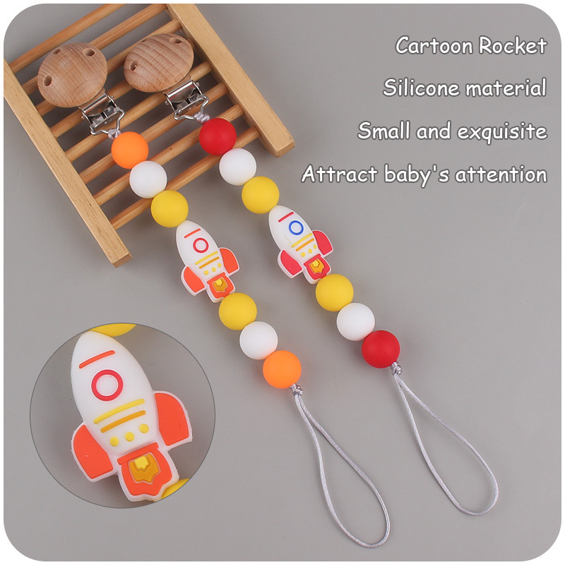 Nuevos suministros para bebés cohete de dibujos animados pequeño mordedor creativo DIY silicona mordedura molar Cadena de pezón cadena anti-caída