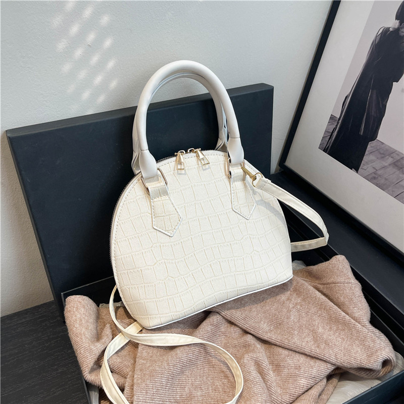 Bolso de mano de piedra para mujeres 2024 nuevo bolso de concha de textura bolso de hombro de moda minimalista estilo elegante mochila
