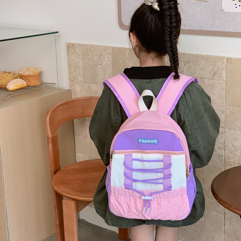 Mochila deportiva de ocio para niños y niñas, mochila de estudiantes de escuela primaria de gran capacidad de aire extranjero 2025 mochila infantil de cuerda de color contrastante
