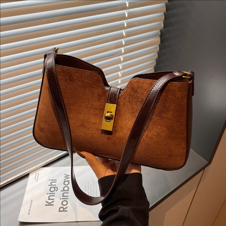 Transfronterizos de alto nivel esmerizado bolsas de brazo portátiles mujeres 2025 invierno nuevo tipo de lujo nicho bolso de hombro de viaje mochila