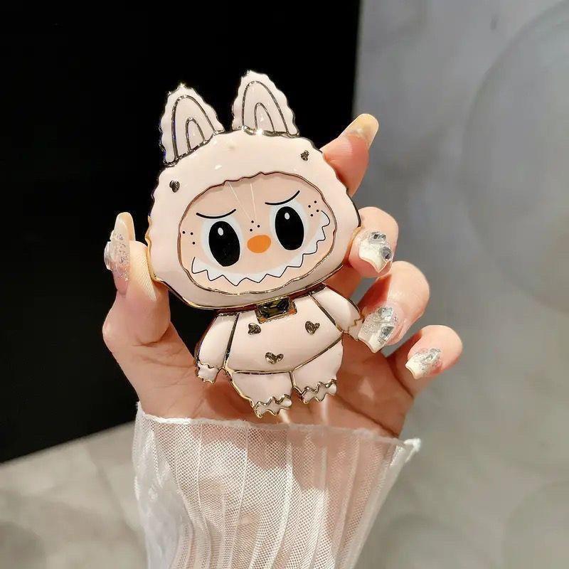 漫画かわいいラブブ携帯電話ホルダーラブブ化粧鏡ホルダーミラー携帯電話ホルダーは回転して折りたたむことができます|undefined