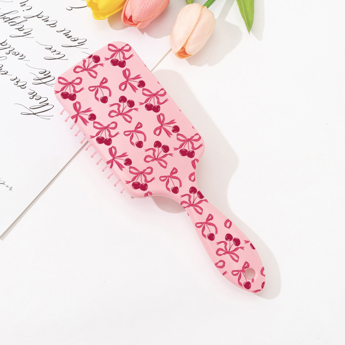 Estilo explosivo transfronterizo peine de colchón de aire con estampado de cereza con lazo lindo rosa peine de peluquería anti-nudo