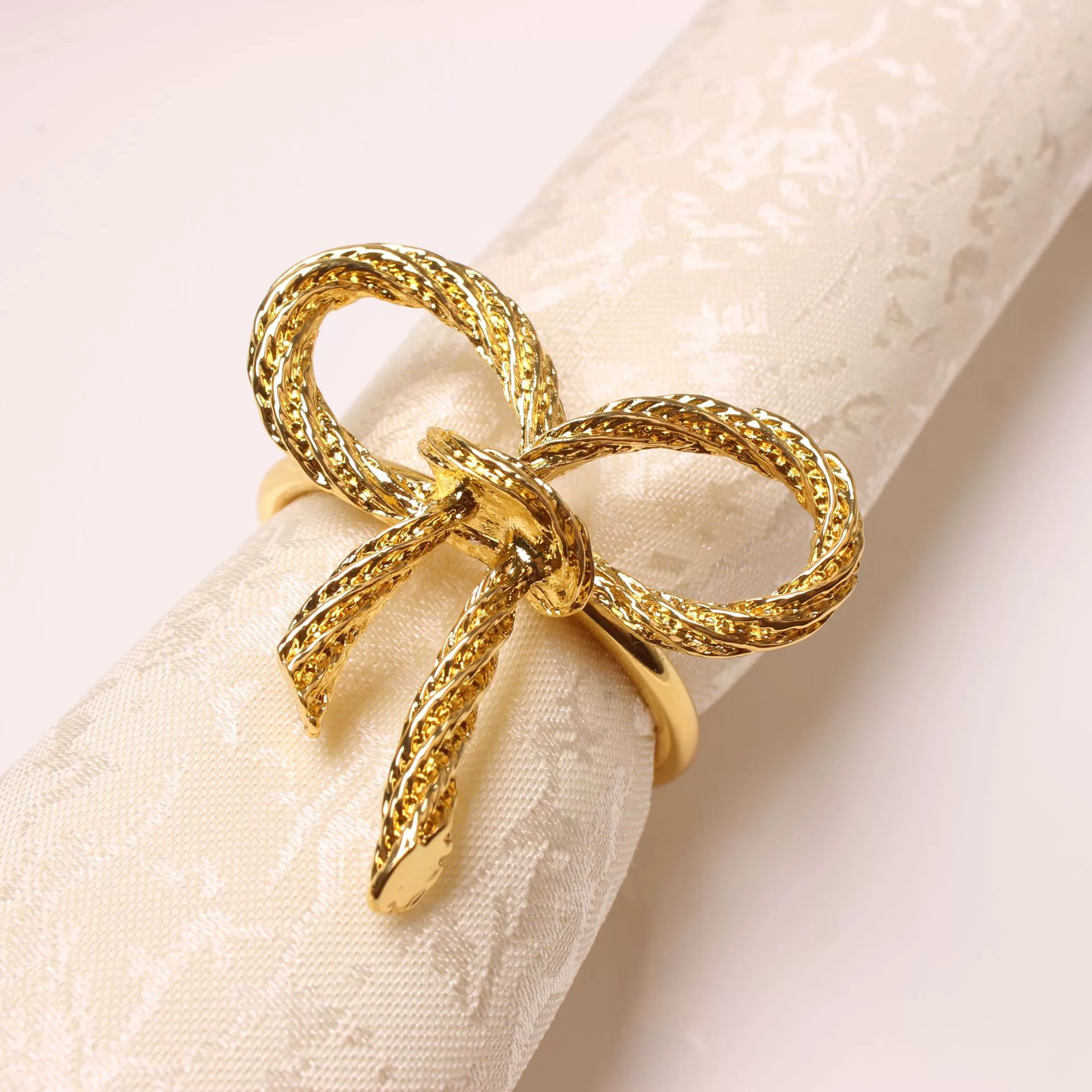 Golden paper napkins with bow, bow tie, fashionable accessory, simple and elegant design