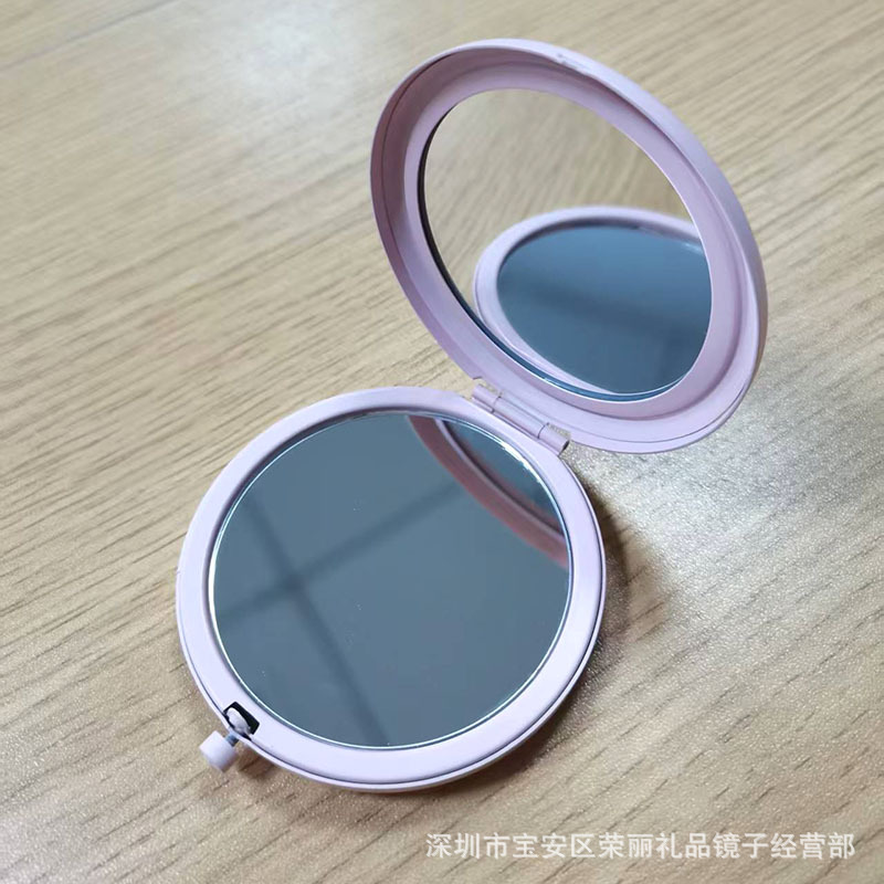 El espejo pequeño de doble luz plegable de metal de alta gama se puede grabar con el logotipo y el espejo de maquillaje portátil de mano al por mayor