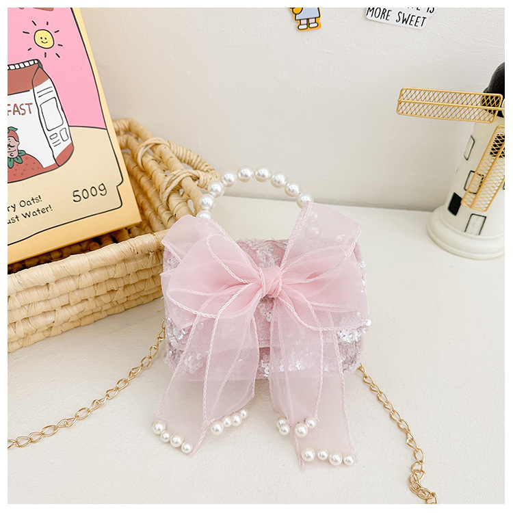 Primavera y verano nuevos bolsos infantiles, bolsos de perlas de arco, bolsos de mano, princesa de estilo extranjero, bolsos de cambio de hombro