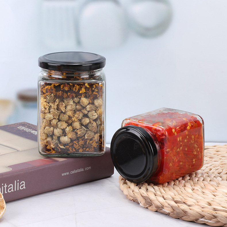 Suministro de botella de vidrio de cuatro bordes sellada transparente cuadrado multi-grano botella de almacenamiento puede botella de miel sub-botella al por mayor